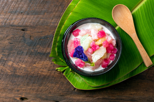 "Red Rubies" Thai dessert is made from truffle wrapped in Tapioca Starch and then coconut milk on top with banana leaf. Thai call " Tab Tim Grob "