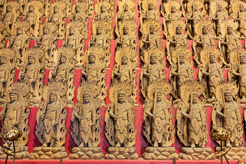 Little wooden statues in ancient japanese shrine