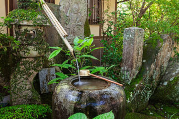 Traditional japanese bamboo purification fountain for purification at entrance of the Japanese temple.