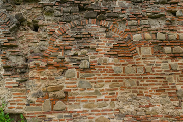 ancient deteriorated brick and stone wall background