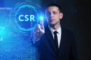 Business, Technology, Internet and network concept. Young businessman working on a virtual screen of the future and sees the inscription: CSR
