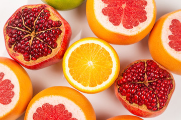 Fototapeta na wymiar Grapefruit, orange, pomegranate, citrus sweetie on white background.