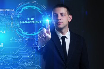 Business, Technology, Internet and network concept. Young businessman working on a virtual screen of the future and sees the inscription: Risk management
