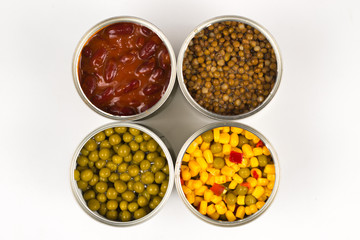 Canned food on white background. Green pea, beans, corn, lentils.