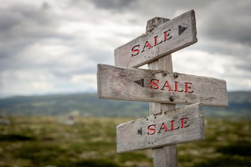 Rustic and wooden Sale signpost outdoors in Nature. Sales, sale, shop, shopping, direction, company, store concept.