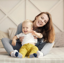 mother and child on bed, funny happy mother and son