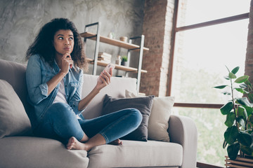 Photo of pretty dark skin curly lady hold telephone deeply minded think over new port text finger...