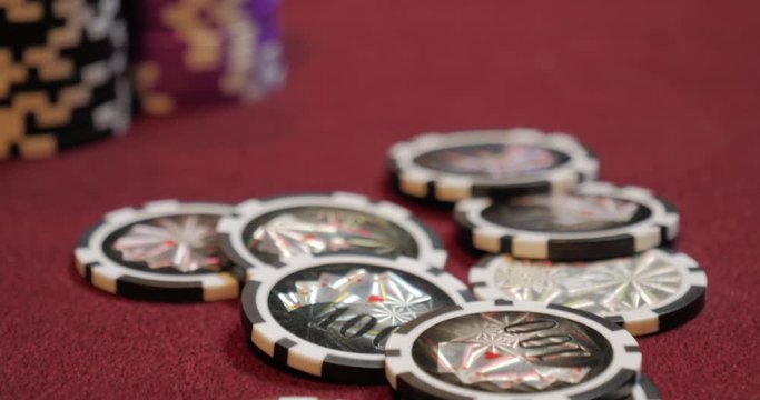 Flying casino chips. Casino chips fall on the playing surface. Casino chips in motion.