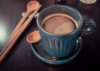 Coffee cup on  brown wooden table