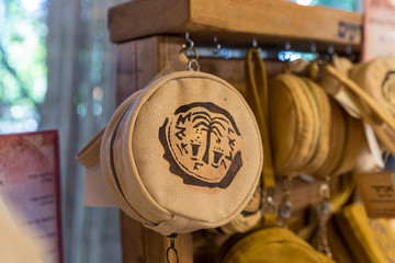Leather decorative bag with the emblem of Ancient Shiloh in the store at the entrance to the Tel Shilo Archaeological Site in Samaria region in Benjamin district, Israel - obrazy, fototapety, plakaty