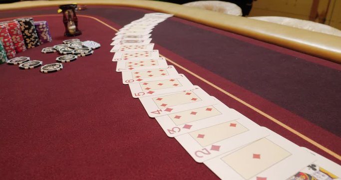 Casino: Dealer man shuffles the poker cards and performing trick with cards