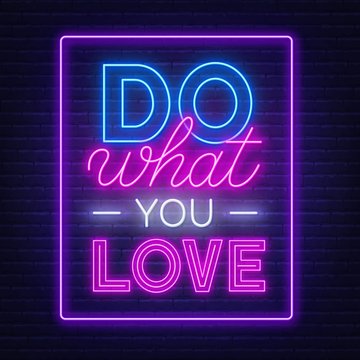 Do what you love neon lettering. Neon sign on brick wall background.
