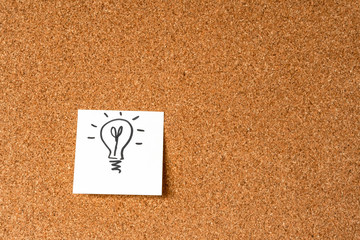 Hand drawing light bulb on sticker on cork, Background, copy space, design element.