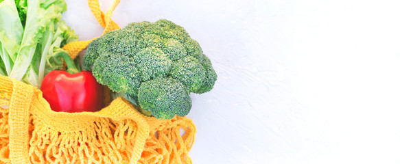 Eco bag with healthy vegetables on a light background.