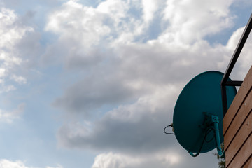 Satellite dish on the roof of the house. The installation point of the satellite dish.
