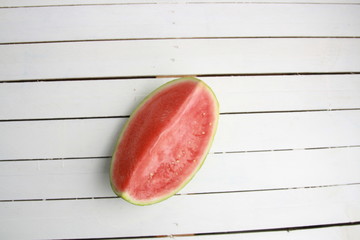 Fototapeta na wymiar cut watermelon on wooden background