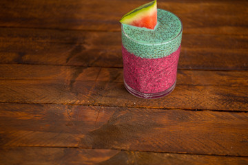 Glass of black chia pudding with watermelon taste