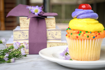 Cupcake on a picnic table before a birthday party