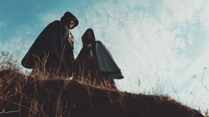 The guy with the girl from the Victorian era standing over cliff and holding hands. Excellent video...