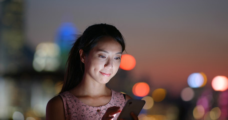 Woman use of smart phone at night