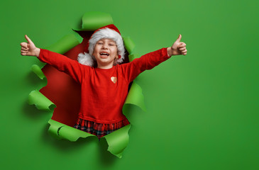 girl in Santa hat on color background