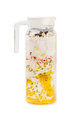 Closeup jug of homemade smoothie of mango, passion fruit, oats, chia seeds, banana, goji berries and coconut milk isolated at white background. Concept of vegan superfood