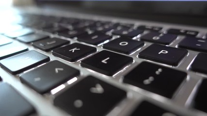 4K video close up shot of used laptop computer or notebook keyboard keys. Close up on letters