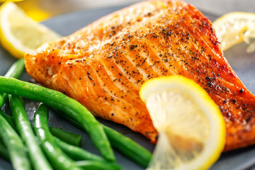 Closeup of baked salmon fish with green beans