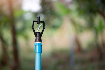 Closeup water sprinkler used in agriculture to keep the ground moist.