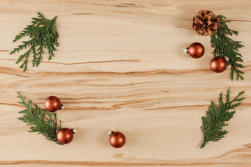 Flat background with wooden desk board top with christmas decorations and ornaments.