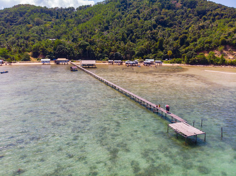 Beautiful aerial image of long wooden jetty with turquoise sea water at Kuala Abai, Kota Belud, Sabah, Borneo