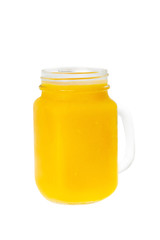 Jar of yellow fresh mango smoothie solated at white background. Concept of vegan healthy lifestyle.