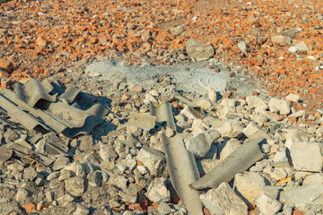 construction garbage peaces of slate and concrete panes on a ground with broken brick 