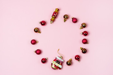 Background with a Little Christmas Balls are Lying on Pink Background in Shape of Circle Christmas Decoration in Shape of Candy and Mittens Christmas Festive Mood Flat Lay