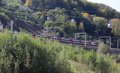 Suburban electric train Lastochka moves in the resort of Krasnaya Polyana. Sochi, Russia