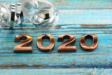 Happy New Year 2020. The number 2020 on blue wooden background.