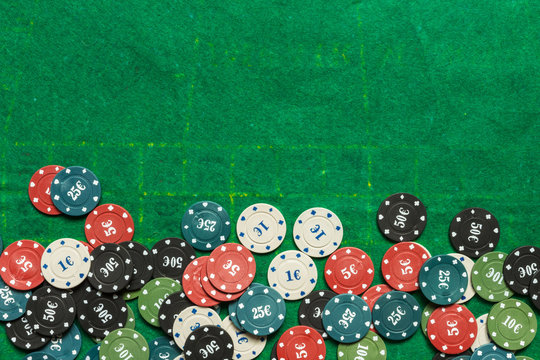 Gambling flat lay.Close-up cards for playing poker on a gaming table in a casino against a background of chips. Background for a gaming business