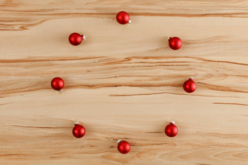 Naklejka na ściany i meble Flat background with wooden desk board top with christmas decorations and ornaments.