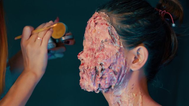 Horror gore flesh violence blood prosthetic makeup by artist, closeup  