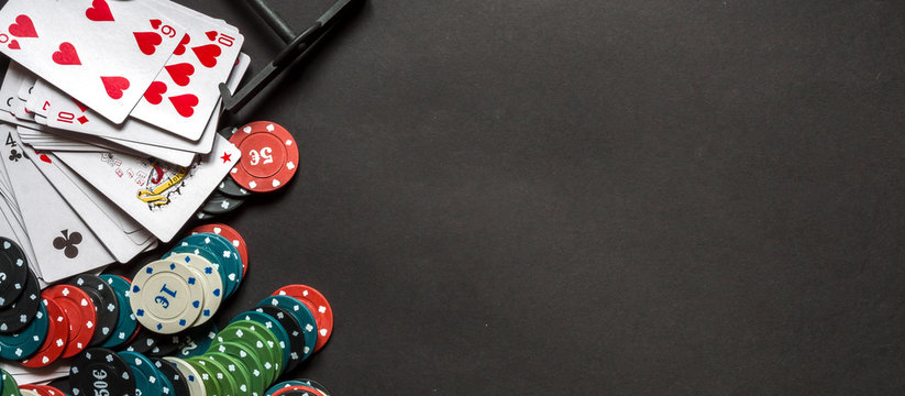 Gambling flat lay.Close-up cards for playing poker on a gaming table in a  casino against a background of chips. Background for a gaming business.Long  baner Stock Photo | Adobe Stock