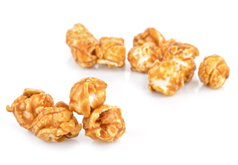 pieces of caramel popcorn on a white background
