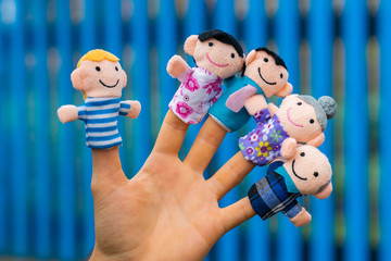 family finger puppet theater. child hand with finger puppets: son, daughter,mum, dad, granny,...