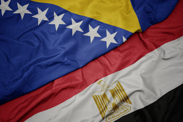 waving colorful flag of egypt and national flag of bosnia and herzegovina.