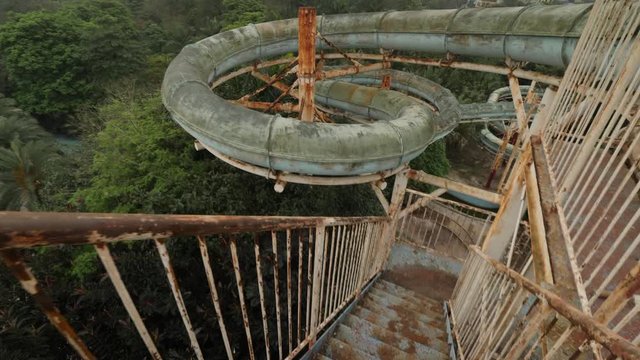 Abandoned waterpark in Hanoi, Vietnam, toboggan, walk down on rotten stairs