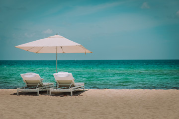 Beach chairs on tropical vacation, travel to sea
