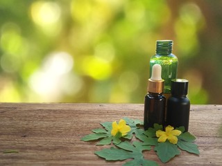 bottle of essential oil and flowers