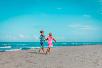 happy girl and boy run on beach, kids enjoy vacation at sea