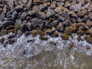 Beach wave hit on rock seaside view from top