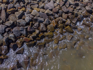 Beach wave hit on rock seaside view from top