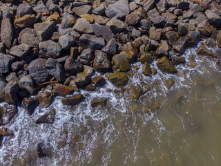 Beach wave hit on rock seaside view from top